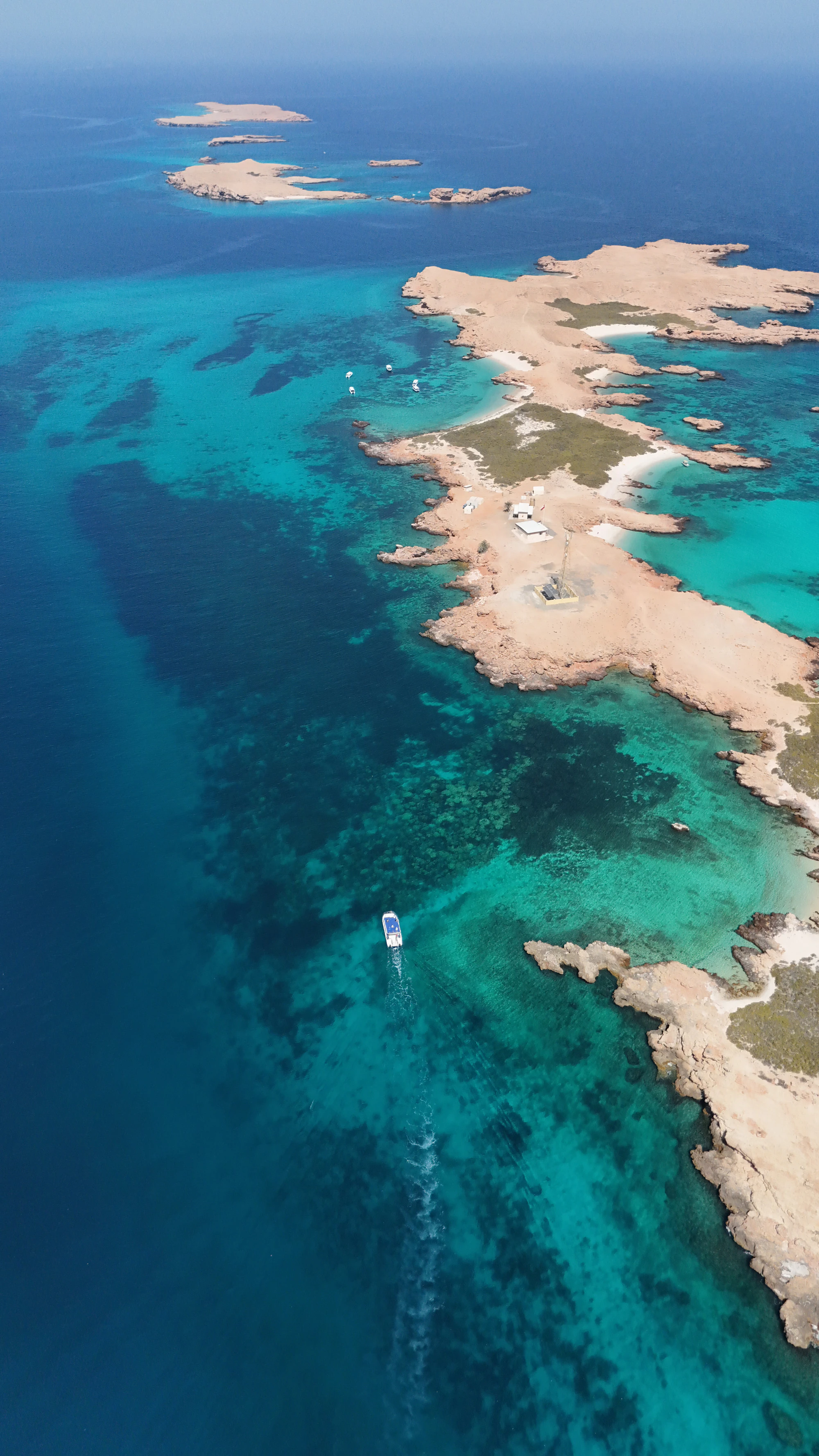 Aerial view of a MolaMola boat heading along the Daymaniyat Islands
