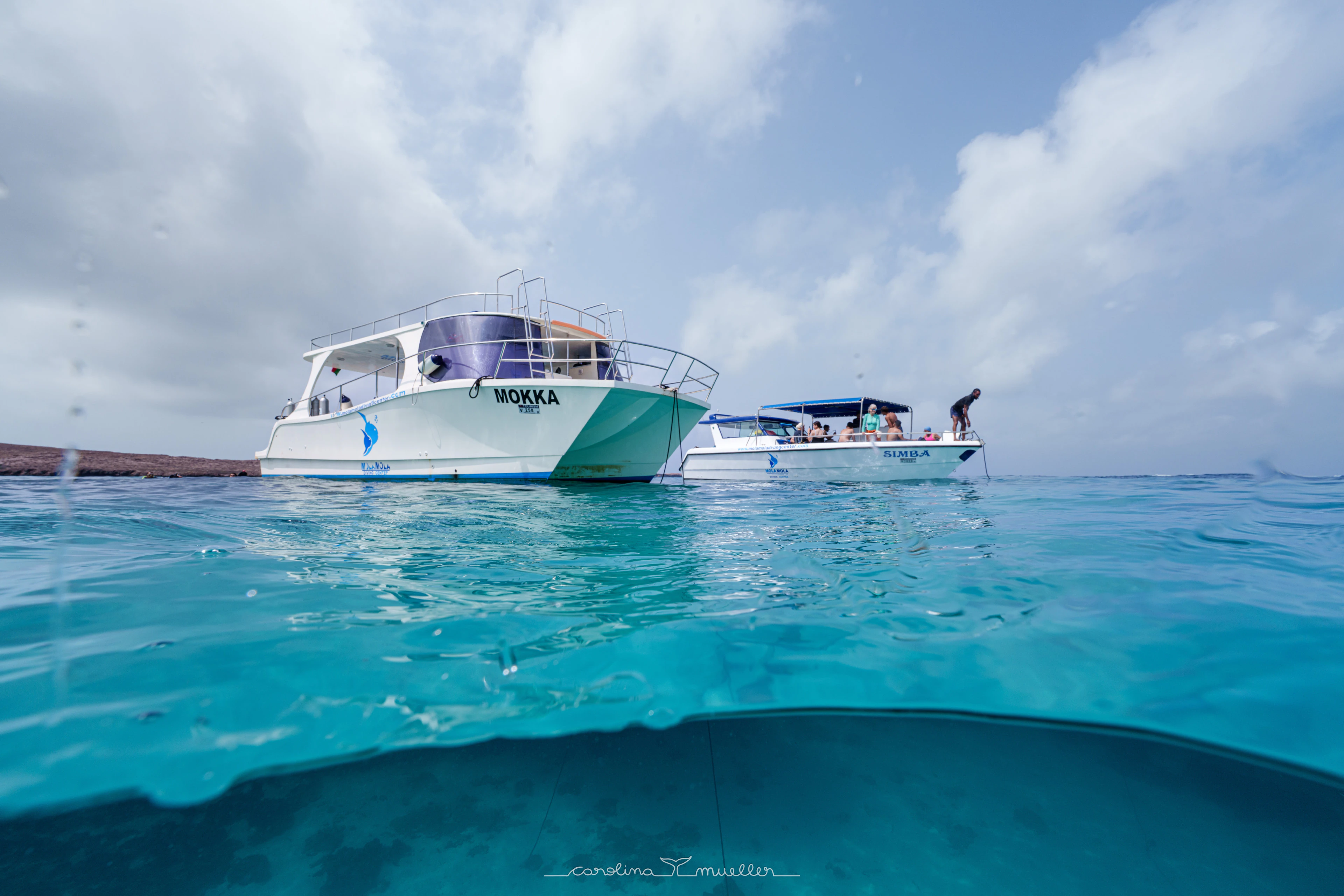 MolaMola boats moored in turquoise water off the islands