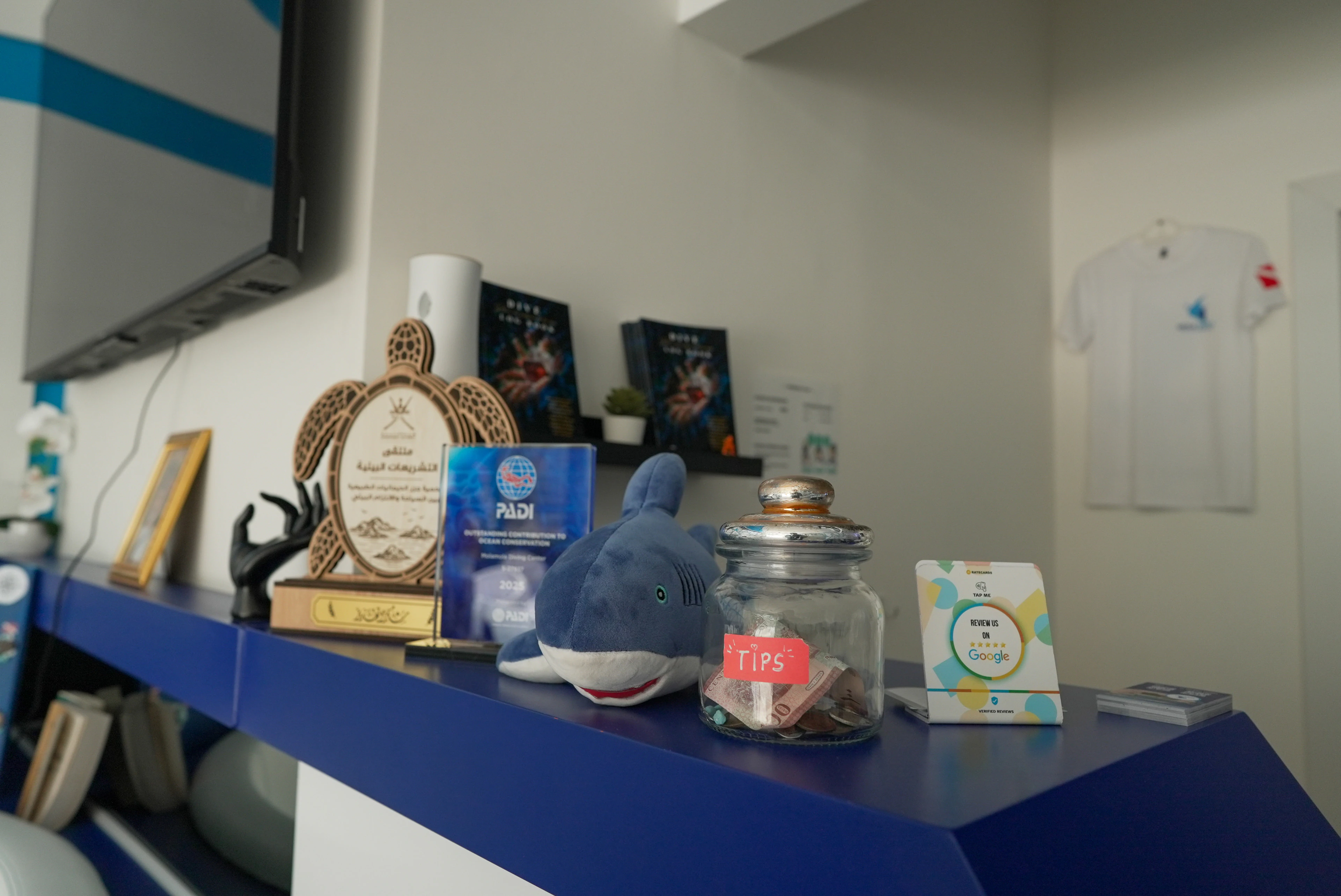 Awards and PADI certificates on the shelf