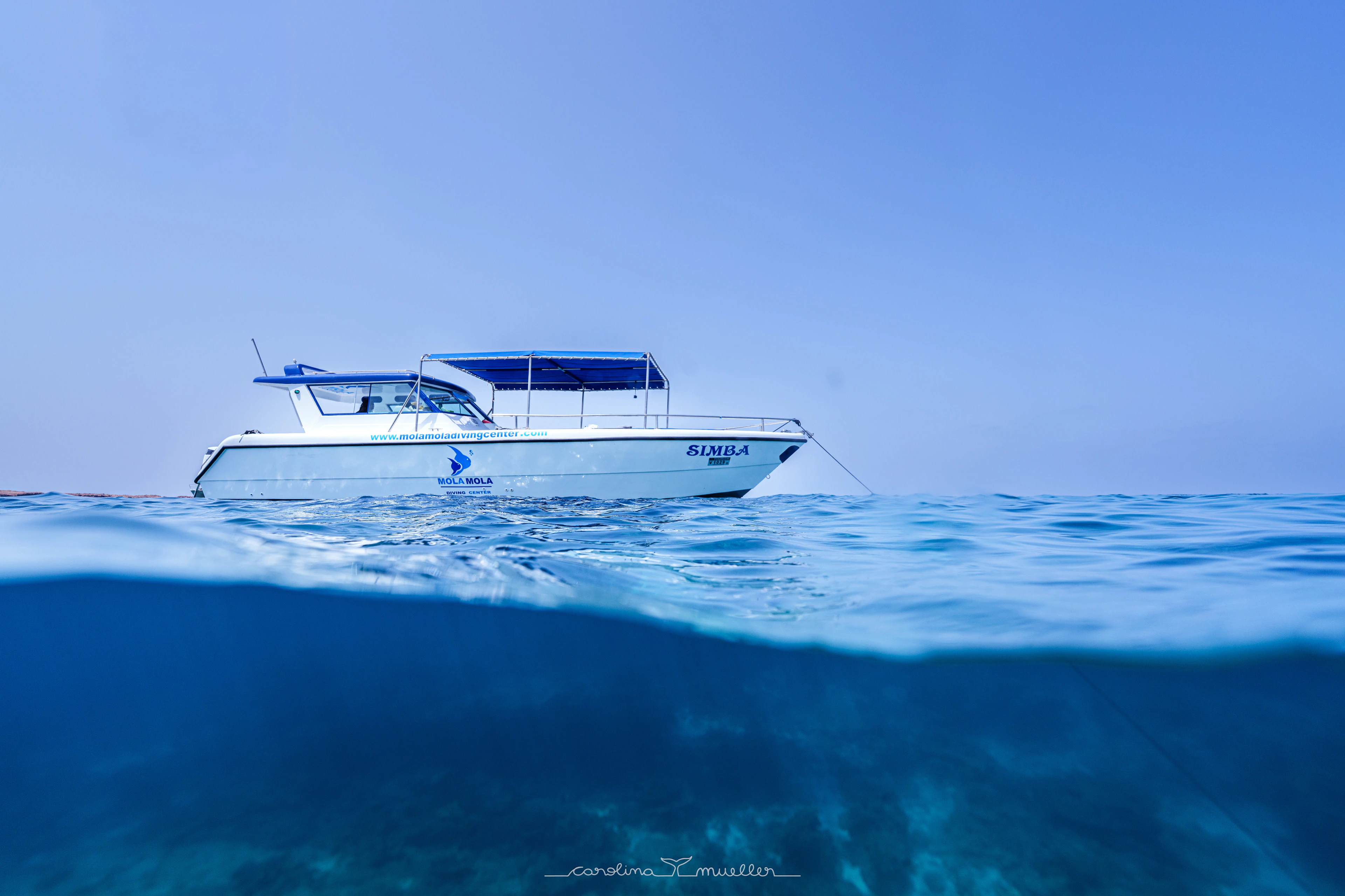 MolaMola boat on calm water, half underwater view