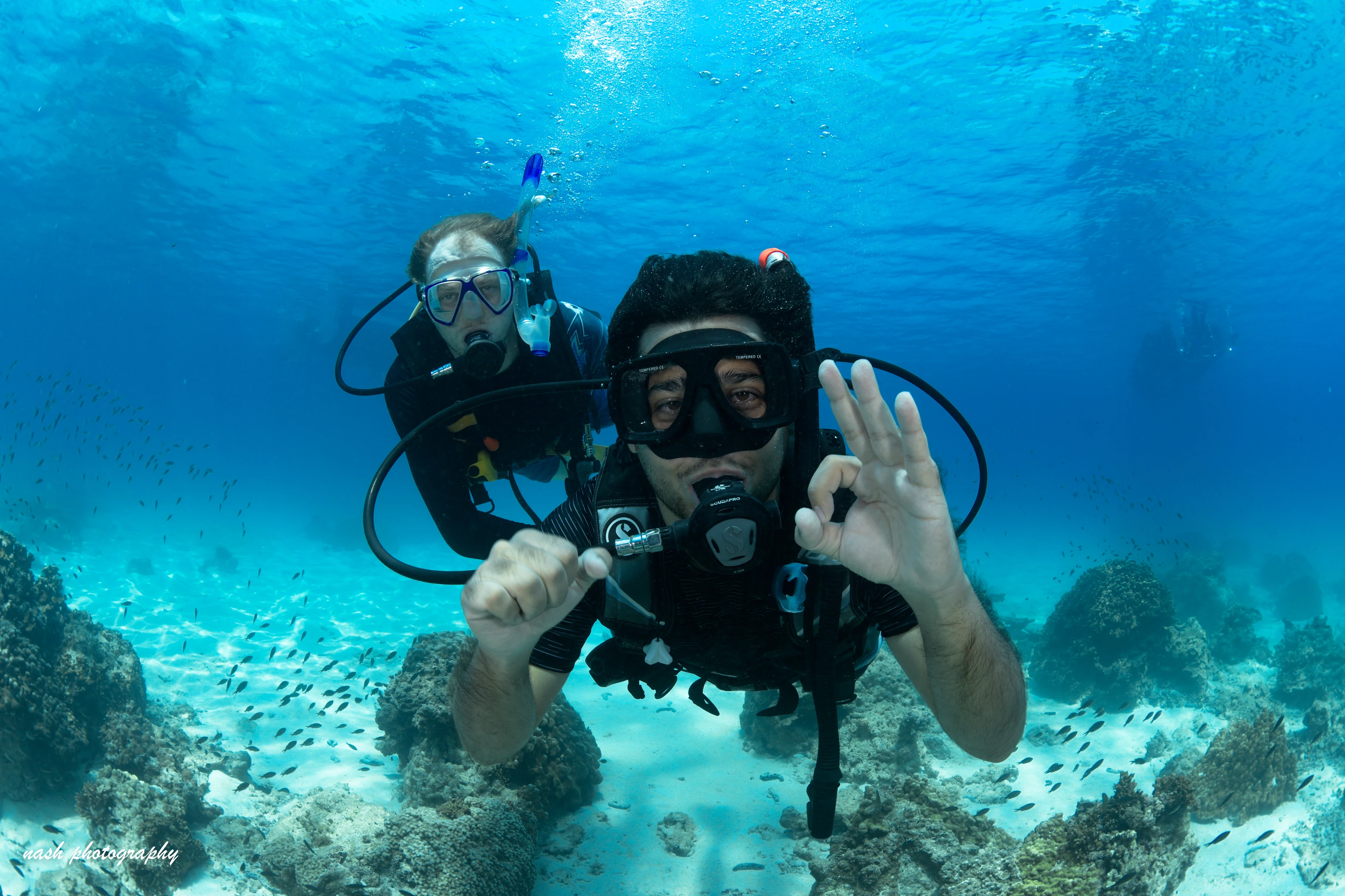 Two divers giving the OK sign