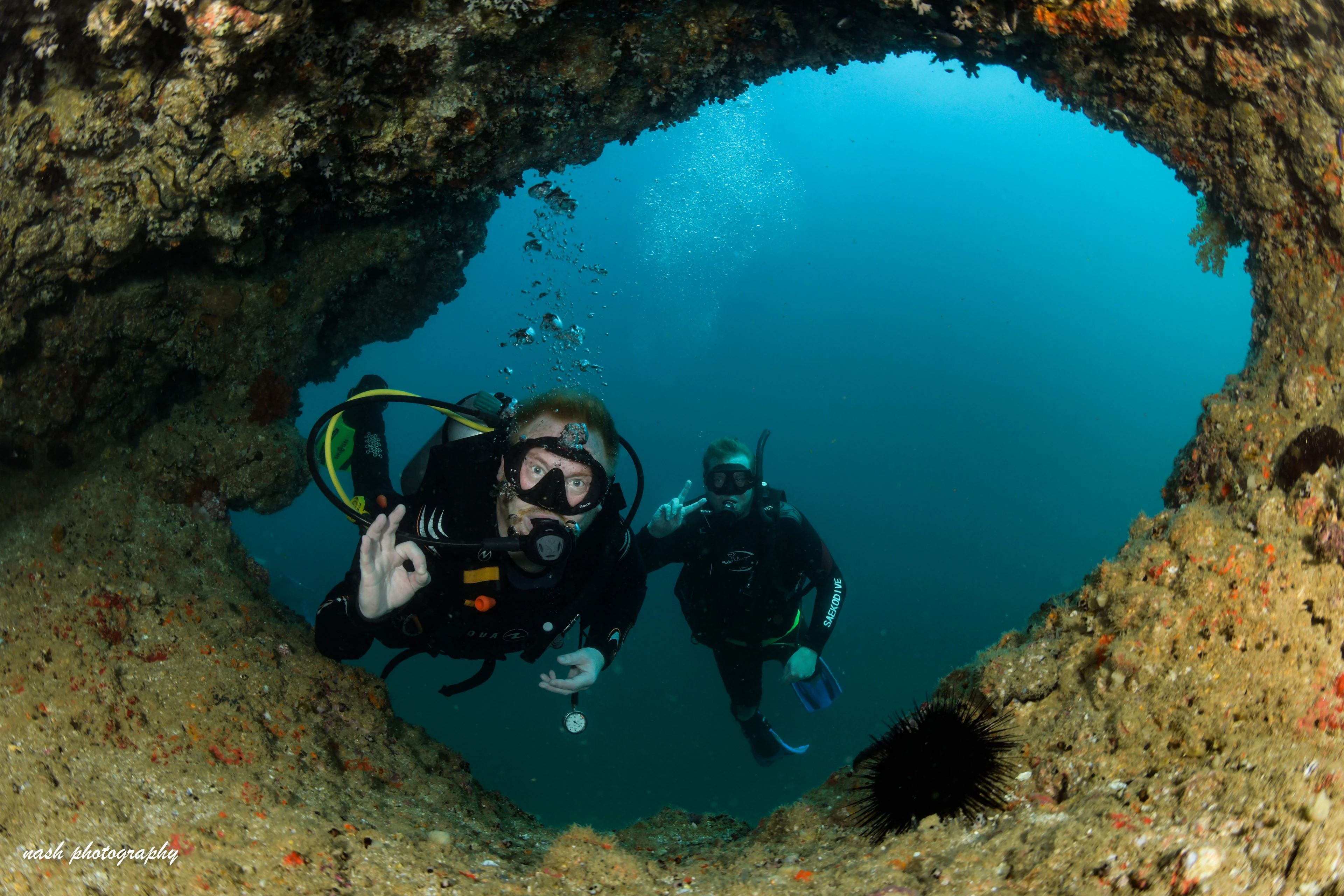 Try divers exploring an underwater cave with their instructor